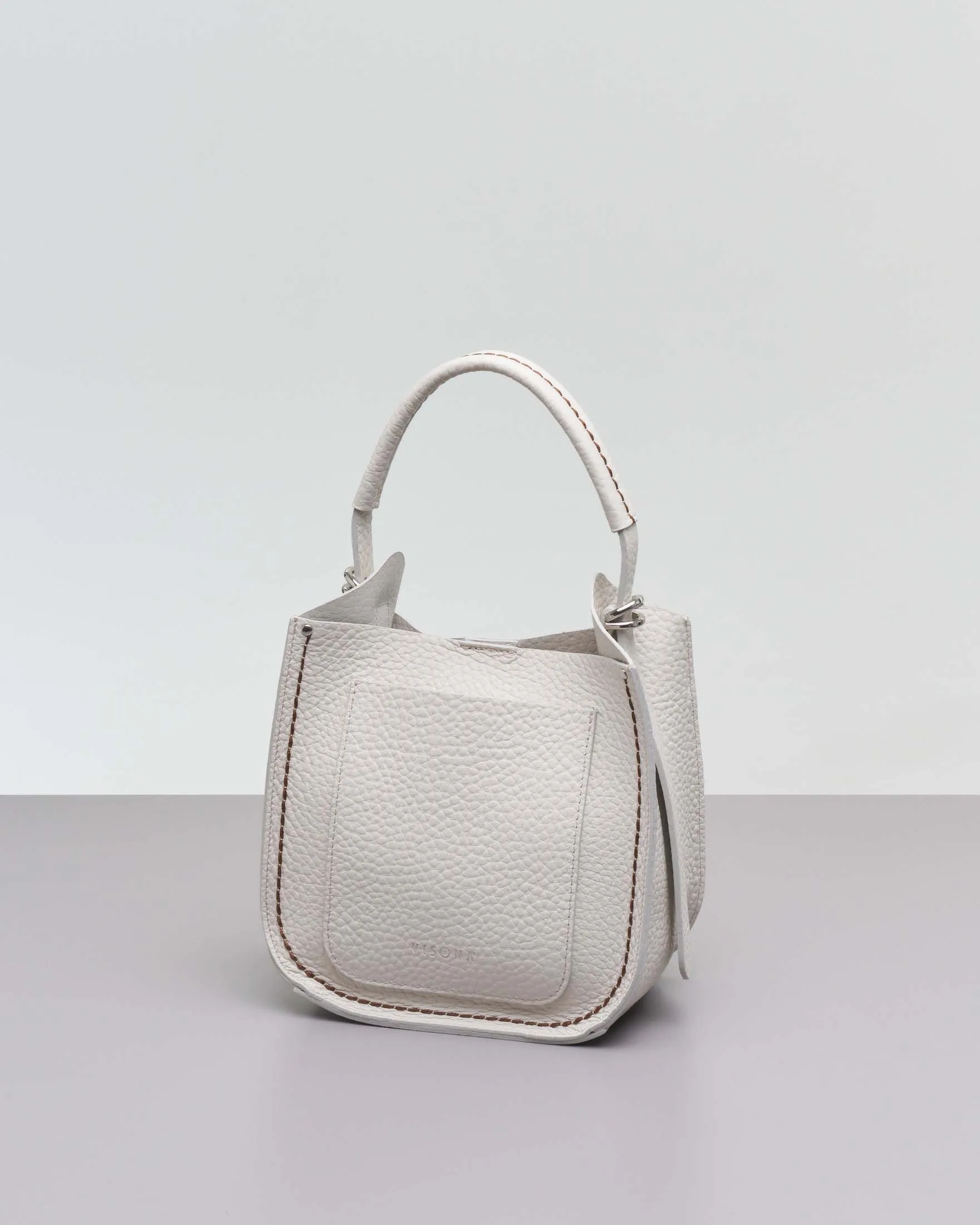 Ivory mini leather hobo bag with contrast stitching and removable shoulder strap.